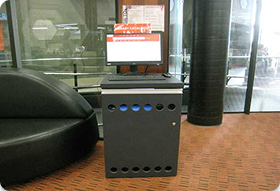 computer on a table with sign of Library Catalogue.