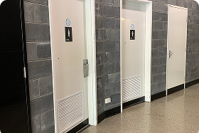 Toilet doors with female and male signs on.