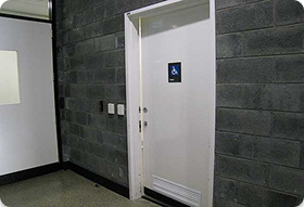 Toilet door with disable sign on.